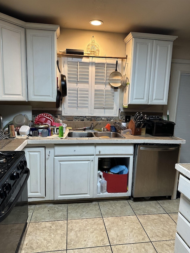 kitchen with sink, white cabinets, gas stove, and dishwasher