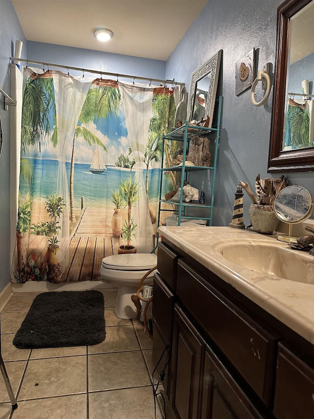 bathroom with tile patterned floors, toilet, and vanity