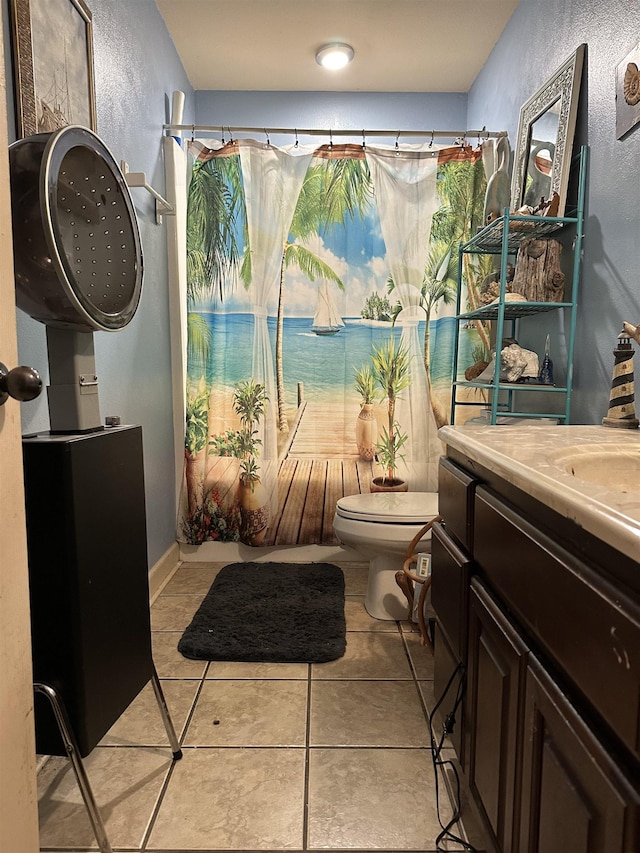 bathroom with vanity, tile patterned floors, and toilet