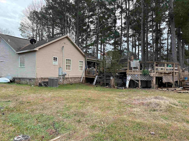 view of yard with a wooden deck and central AC