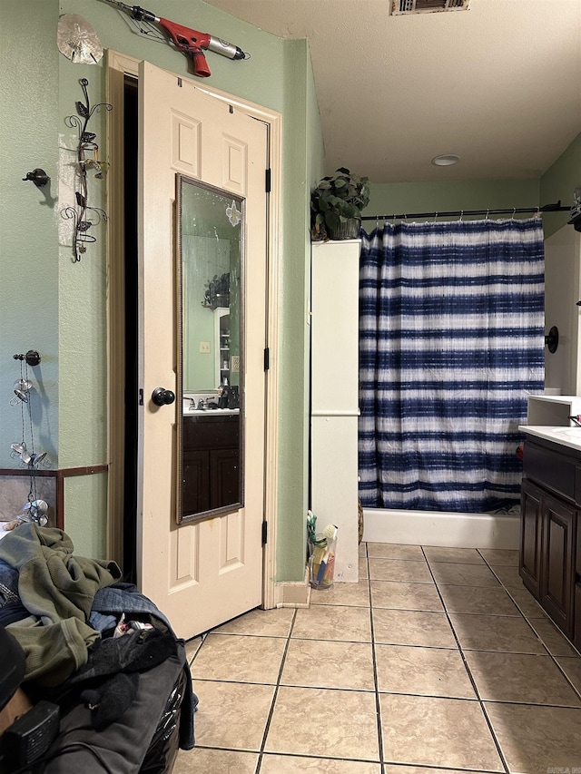 bathroom featuring tile patterned floors and vanity