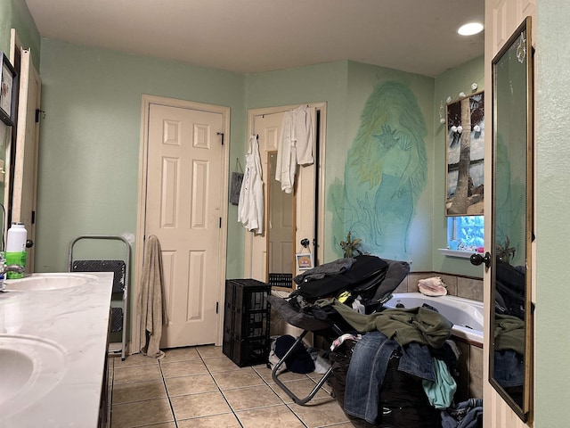 bathroom featuring vanity, a bath, and tile patterned floors