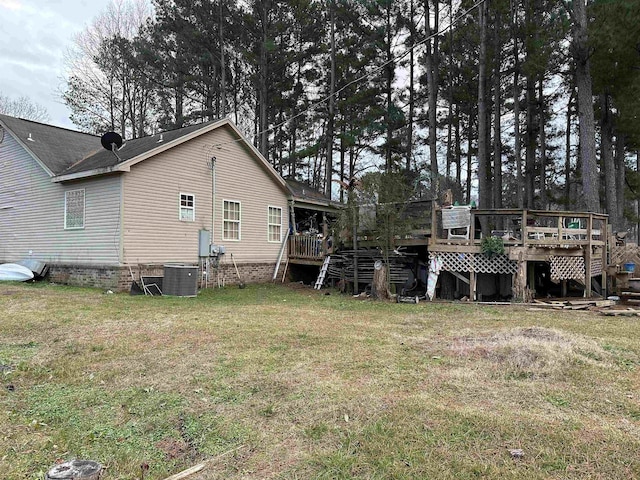 back of house with a lawn and a deck