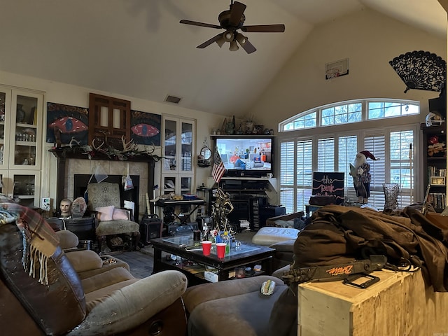 living room with a fireplace, high vaulted ceiling, and ceiling fan