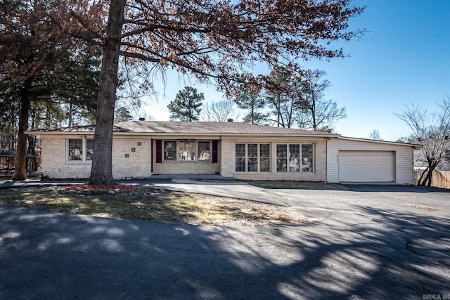 ranch-style home featuring a garage