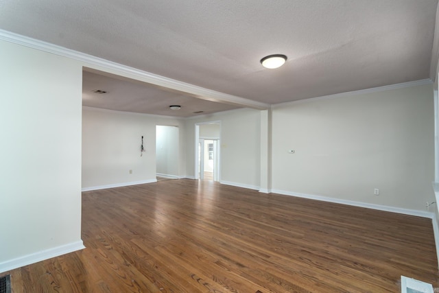 spare room with dark wood-type flooring, a textured ceiling, and ornamental molding