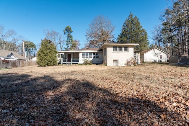 rear view of house featuring a lawn