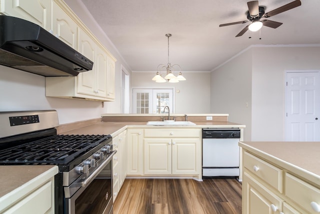 kitchen featuring stainless steel gas stove, dishwasher, sink, decorative light fixtures, and ornamental molding