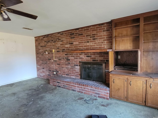 unfurnished living room featuring brick wall, a brick fireplace, and ceiling fan