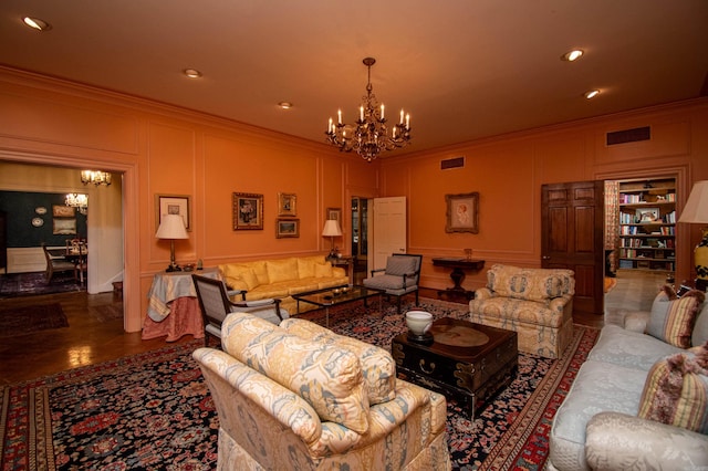 tiled living room with built in features, ornamental molding, and an inviting chandelier