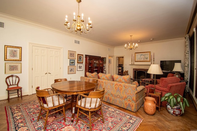 dining room featuring parquet floors, a notable chandelier, a fireplace, and crown molding