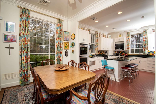 dining space featuring crown molding and ceiling fan