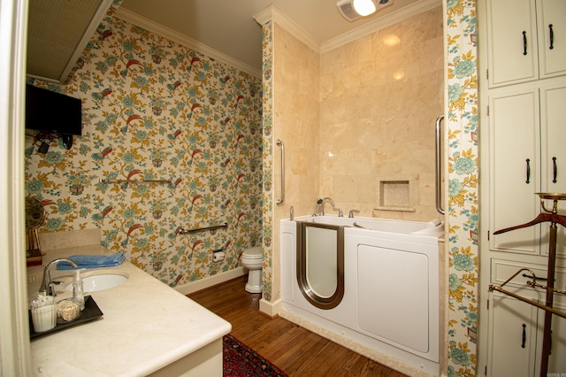 clothes washing area with hardwood / wood-style floors, sink, tile walls, independent washer and dryer, and ornamental molding