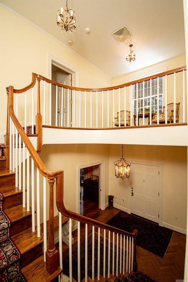 stairs with parquet flooring and an inviting chandelier