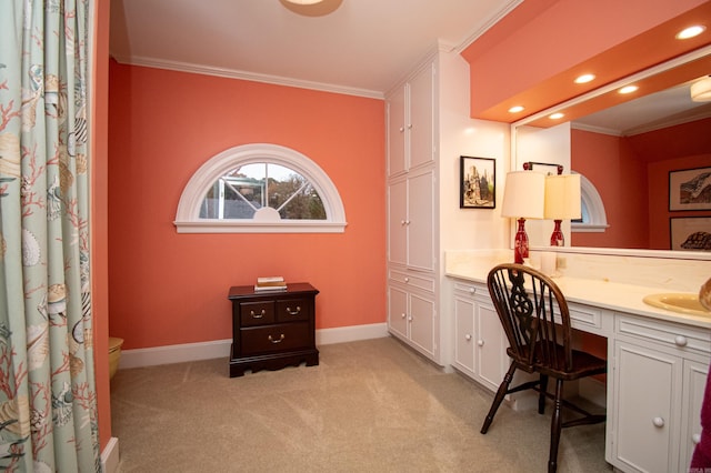 carpeted office featuring crown molding and built in desk