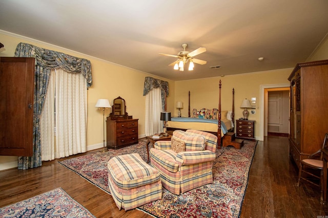 bedroom featuring dark hardwood / wood-style floors, ornamental molding, and ceiling fan