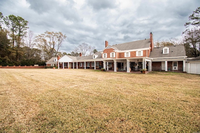 back of property with a lawn