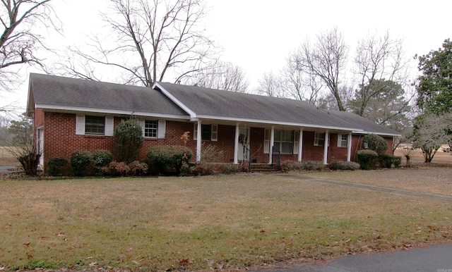 single story home with covered porch and a front lawn