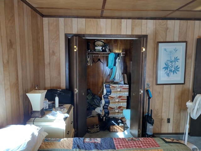 bedroom featuring a closet and wooden walls