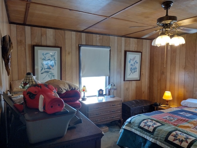 bedroom with wooden ceiling, wooden walls, and ceiling fan