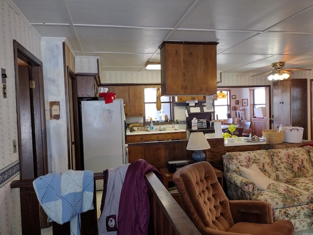 kitchen featuring ceiling fan and white fridge