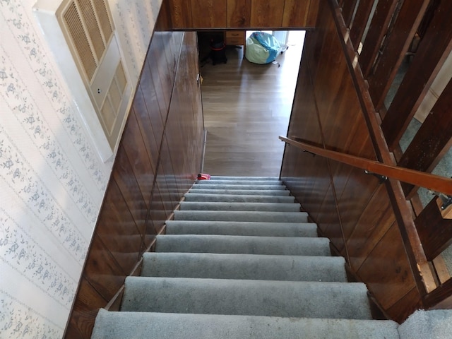 staircase with dark hardwood / wood-style floors