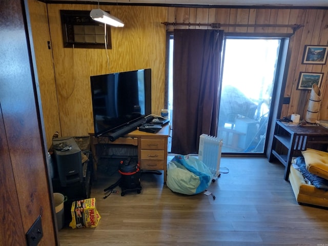 interior space featuring wooden walls, hardwood / wood-style floors, and radiator