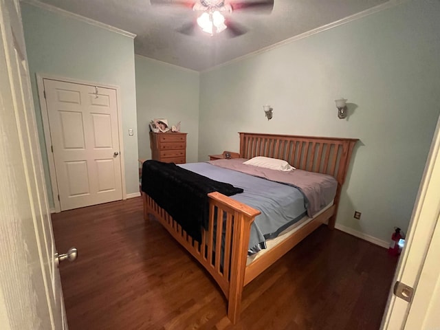 bedroom featuring dark hardwood / wood-style floors, ceiling fan, and ornamental molding