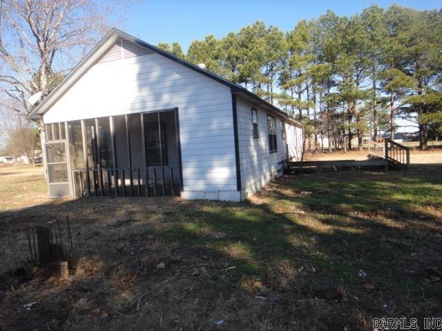 back of house featuring a sunroom