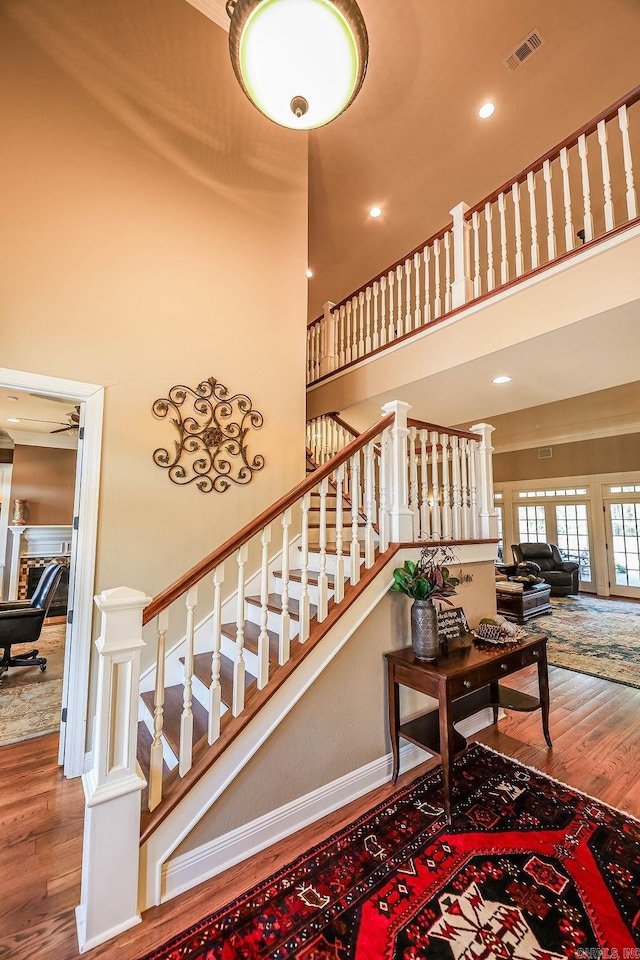 stairs featuring high vaulted ceiling, dark hardwood / wood-style floors, and ceiling fan