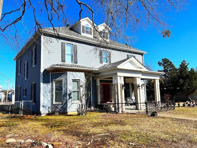 exterior space featuring covered porch and a front yard