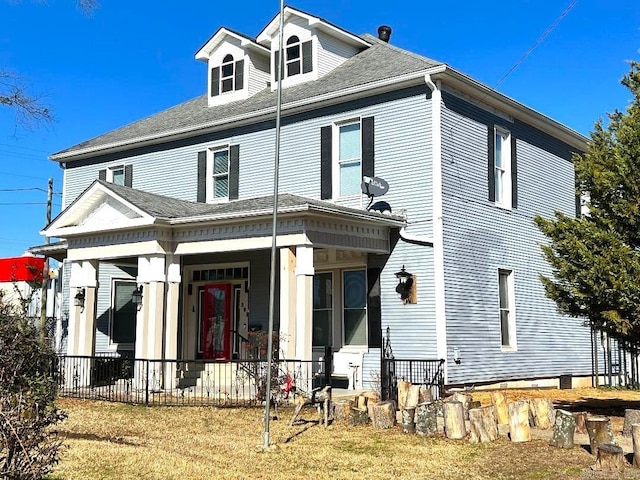 exterior space featuring covered porch and a lawn