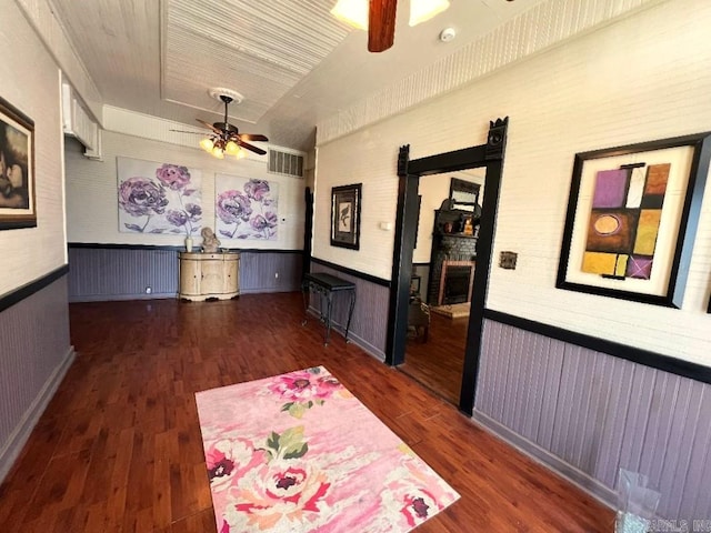 interior space featuring ceiling fan and dark wood-type flooring