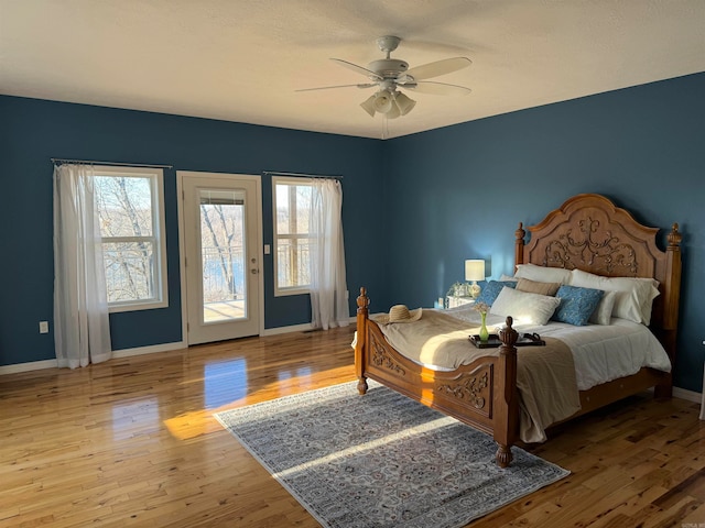 bedroom with light hardwood / wood-style flooring, ceiling fan, and access to exterior