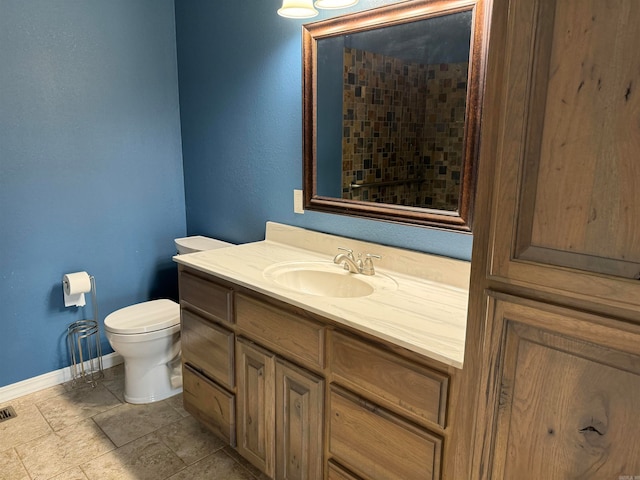 bathroom featuring tile floors, toilet, and vanity