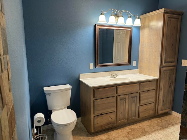 bathroom featuring vanity, tile flooring, and toilet