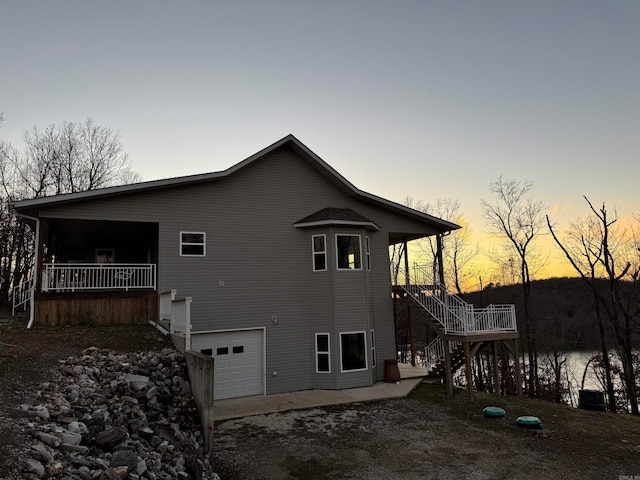 property exterior at dusk featuring a garage