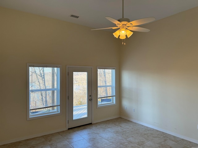 tiled spare room featuring ceiling fan and high vaulted ceiling