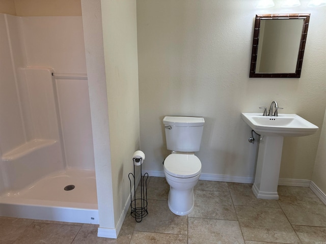 bathroom with walk in shower, tile flooring, and toilet