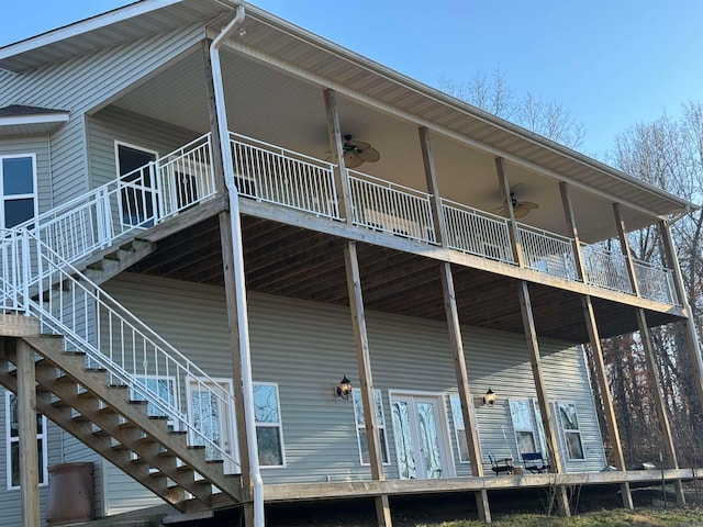 rear view of house featuring a balcony and ceiling fan