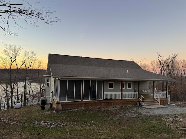 view of back house at dusk