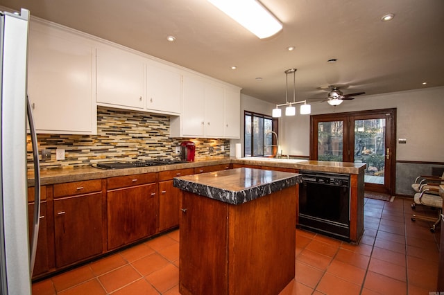 kitchen with a wealth of natural light, sink, black appliances, and a kitchen island