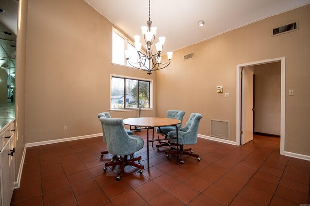 tiled dining room featuring a towering ceiling and an inviting chandelier