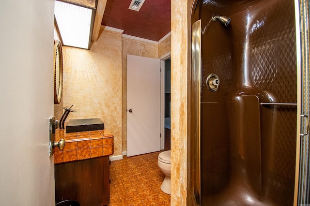 bathroom featuring crown molding, walk in shower, toilet, and tile floors