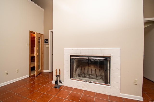 details with dark tile floors and a tiled fireplace