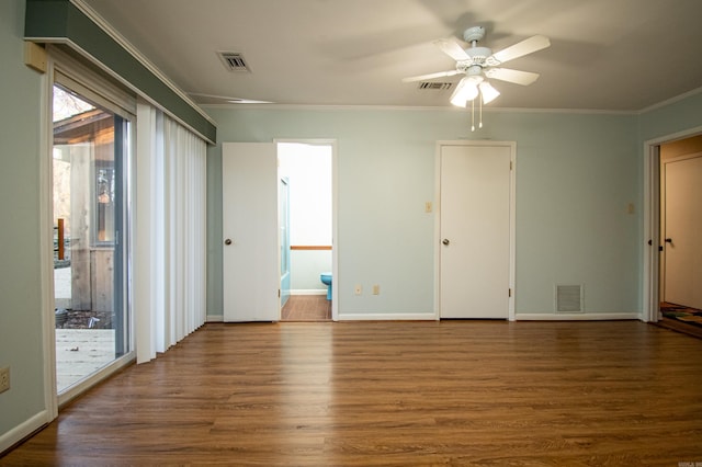 spare room with ornamental molding, ceiling fan, and dark hardwood / wood-style flooring