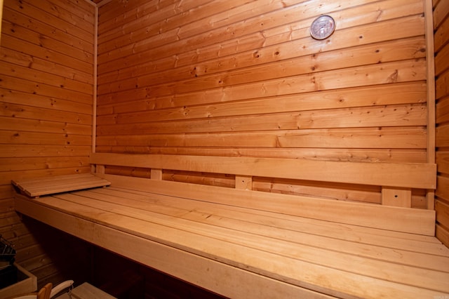 view of sauna featuring wooden walls