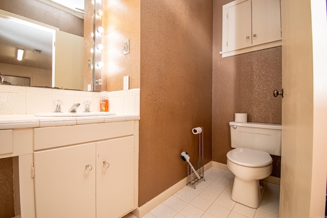 bathroom featuring backsplash, vanity, toilet, and tile floors