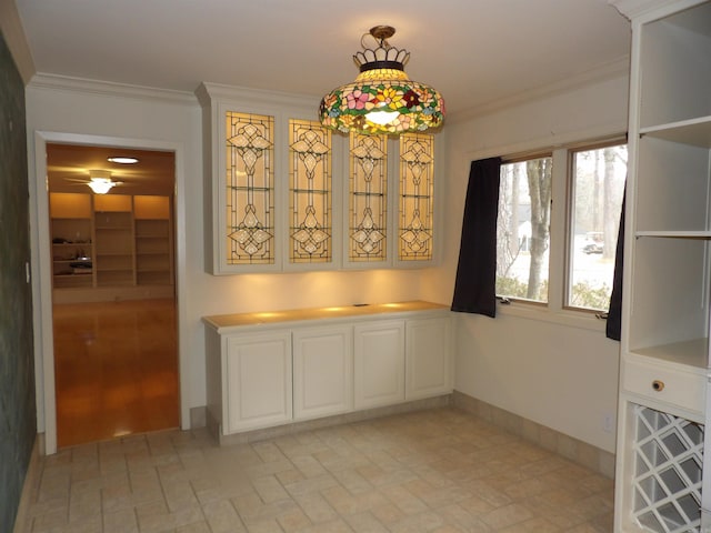 unfurnished dining area with crown molding