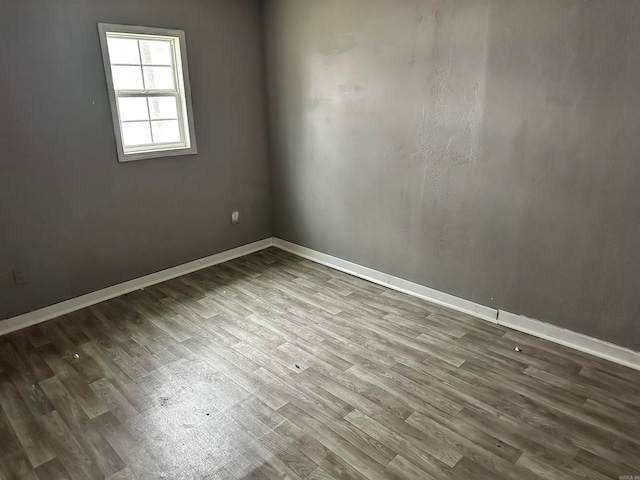 unfurnished room with wood-type flooring